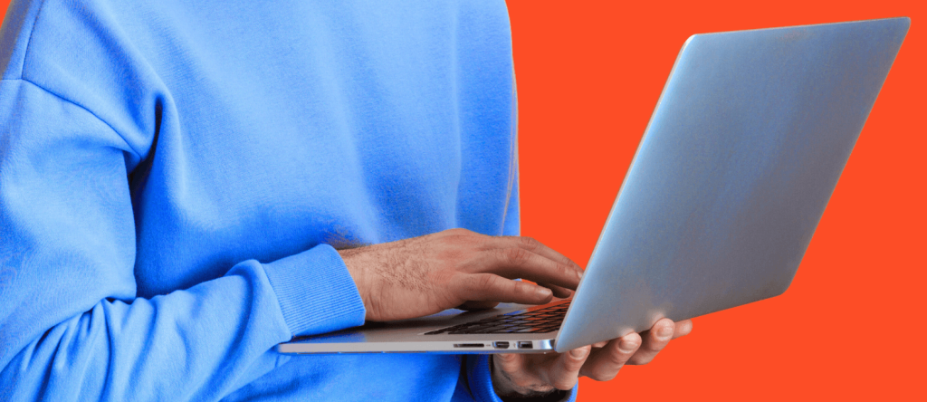 Man typing on keyboard with orange background