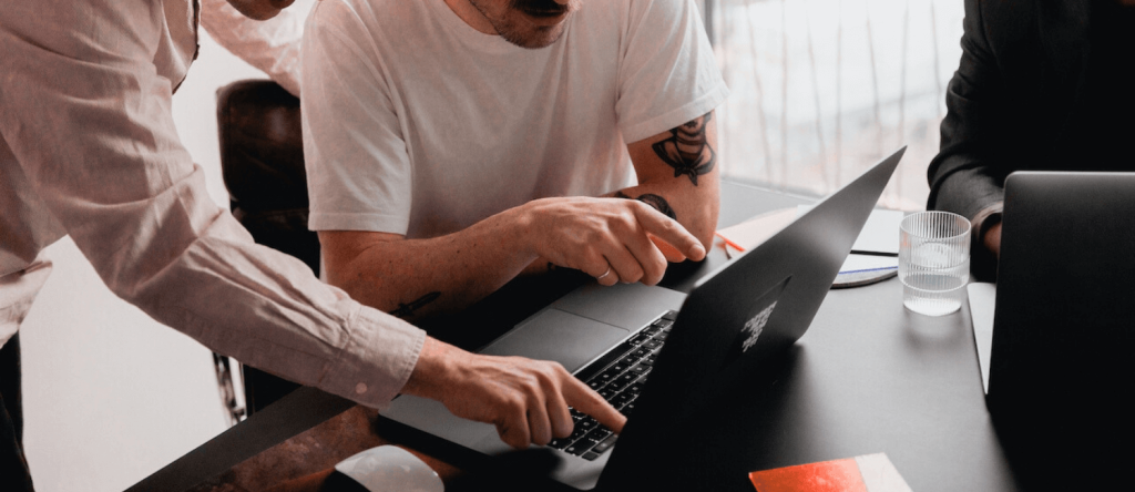 Office meeting with laptop with men reading a laptop screen
